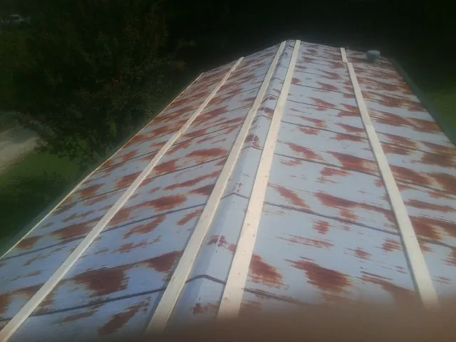 Rusted metal roof panels with new wood purlins before replacement — Storm Damage Roof Repair in Russiaville by Roofing Brothers